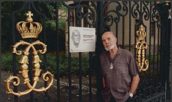 Man leaning against gate