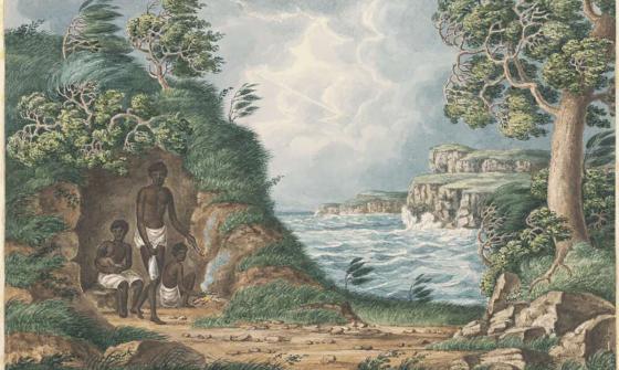 Family of aboriginal people sitting by a bay surrounded by trees.