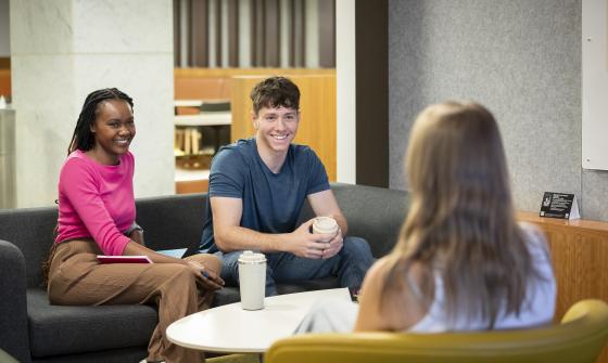 Three young people sitting on couches in the Library's Lower Ground Floor 