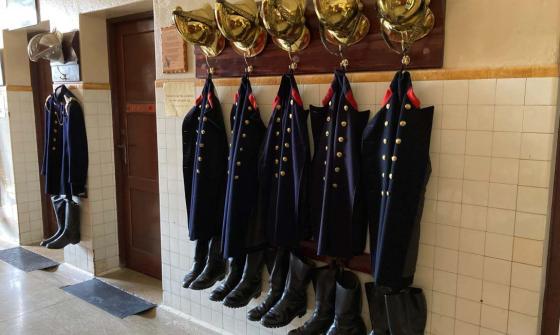 Turnout gear for firemen hanging in the engine bay of the Canberra Fire Museum