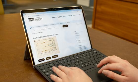 Someone using a laptop looking at the catalogue record for the Rex Nan Kivell collection of maps in the National Library catalogue
