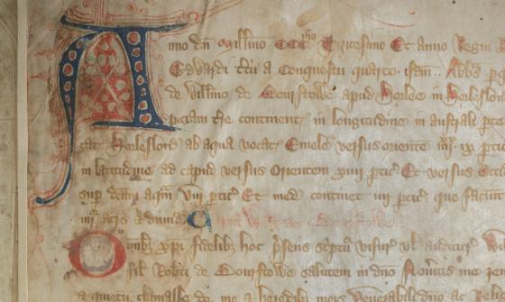 Close up of page of old, rare Latin book with a stylised letter A in the top left