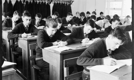 boys sitting at desks in a school classroom