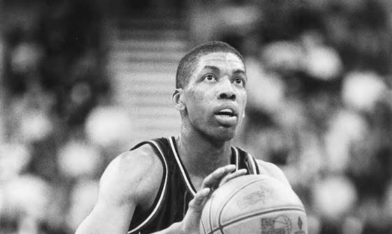 Black and white photo of basketball player, Robert Rose, poised to shoot at the goal
