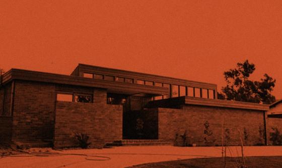 Orange and black stylised image of a house