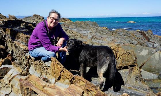 Photo of 'Dog Beach' author at the beach with her dog Banjo on a sunny day