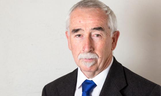 Man, Gary Humpheries, wearing a suit with a stern expression