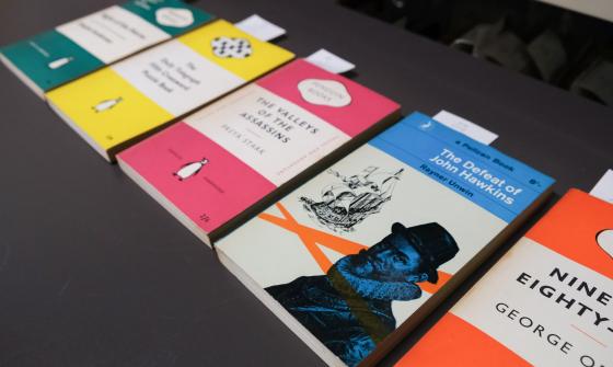 Five differently-colour books laid out in a row, all published by Penguin Random House and featuring their well known cover design