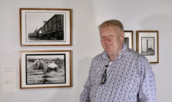 Mike Bowers standing in the 'Fit to Print' exhibition gallery