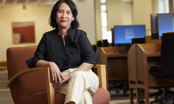 Rima Febriani sitting on an armchair in the Main Reading Room
