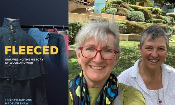 On the left is the cover of the book 'Fleeced: Unraveling the history of wool and war' by Trish Fitzsimons and Madelyn Shaw. On the right are two smiling women outside on a sunny day with grass and bushes in the background.