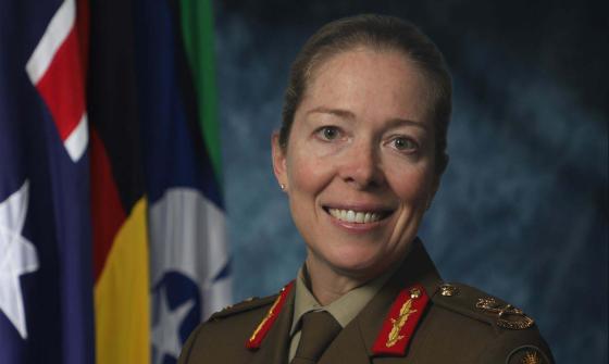 A smiling woman dressed in military clothing