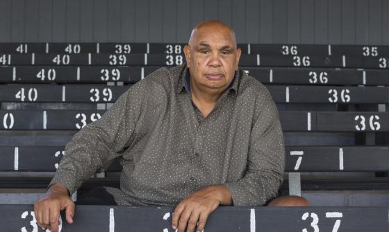 An man sits in an empty grandstand