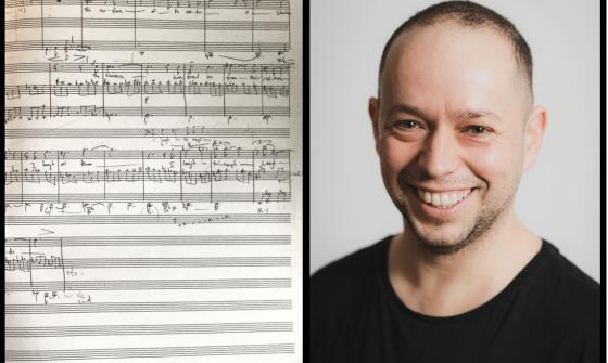 A page of handwritten music notations with composer Luke Styles wearing a black t-shirt
