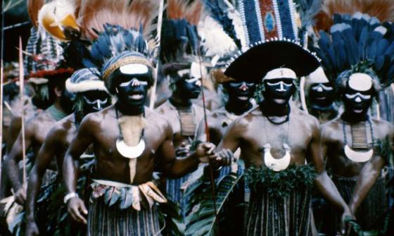 Group of Papua New Guineans in traditional dress, including feathered headpieces, at the Independence Day Celebration.