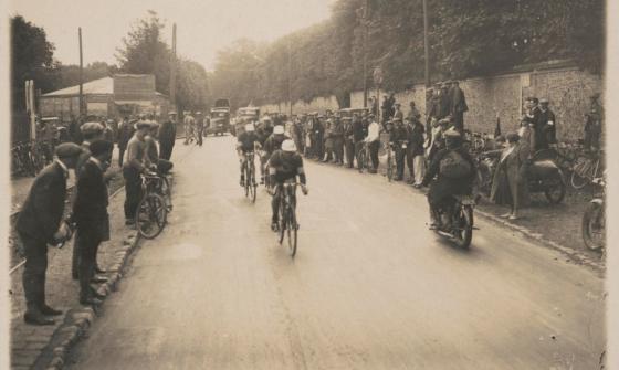 Cyclists racing on a road lined with spectators