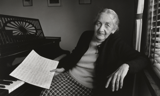 Black and white photo of Miriam Hyde sitting at a piano