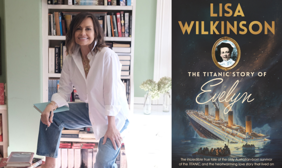 A woman sitting on a tool with piles of books and a bookcase behind her