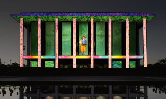 A colourful projection on the National Library of Australia building featuring a figurine reading a book while holding a lamp