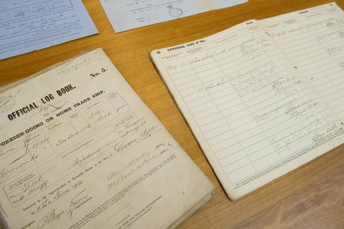 Old documents including an two official log books of shipping activity