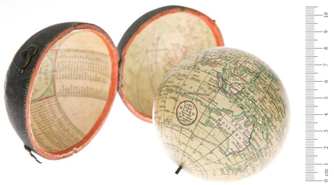 A small globe positioned to show Australia and it's shagreen case