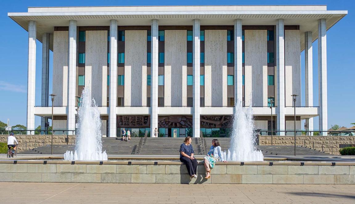 The front of the National Library building showing fountains and steps