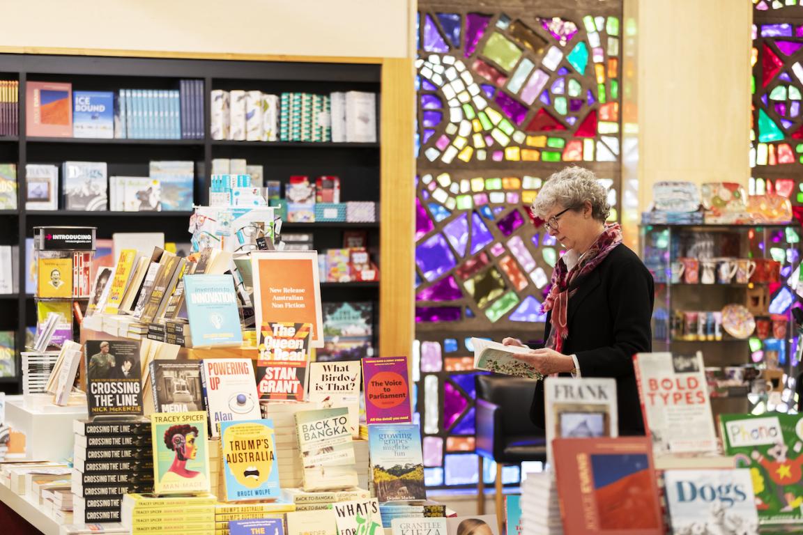 Woman browsing books on display at the Library's Bookshop