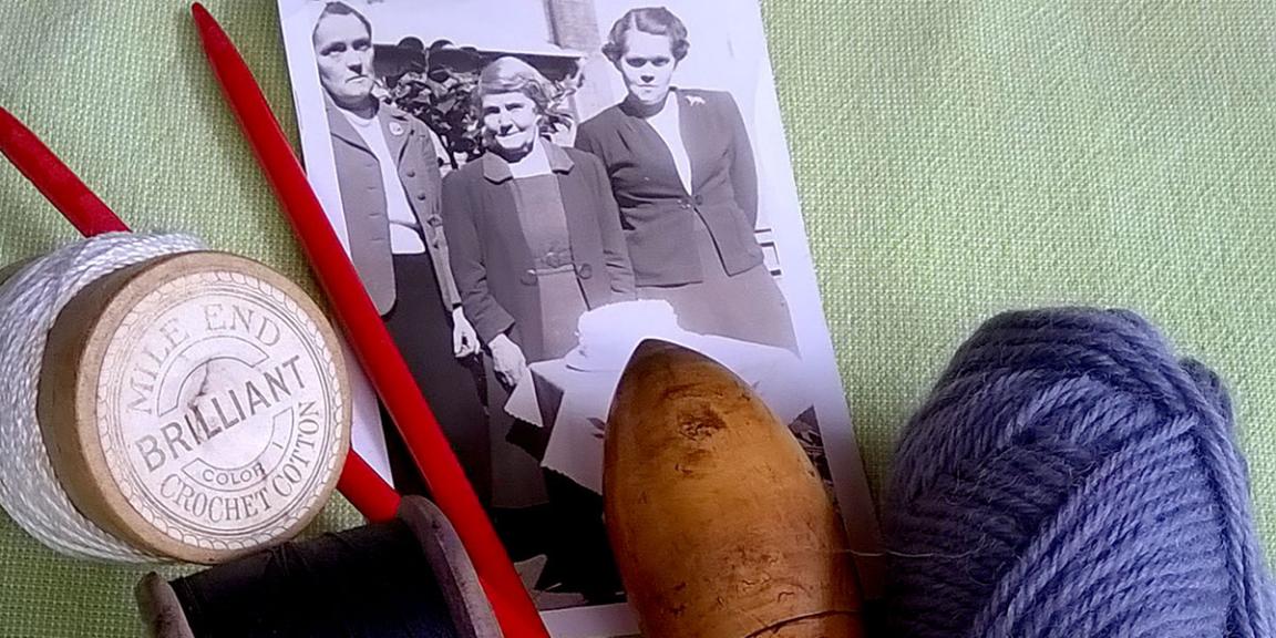An image of a black and white photo, some yarn and sewing cotton and knitting needles on a green background. 