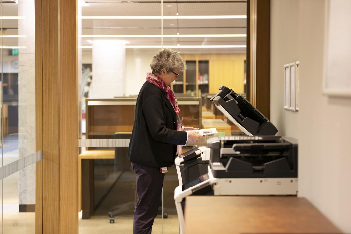 Woman using printer/photocopier in the Special Collections Reading Room