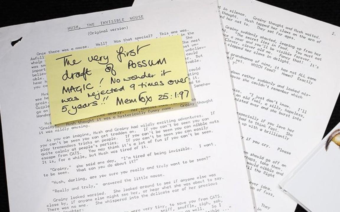 A photograph showing a typed manuscript with a sticky note on top that reads, “The very first draft of Possum Magic! No wonder it was rejected 9 times over 5 years!” The manuscript is part of Mem Fox’s collection.
