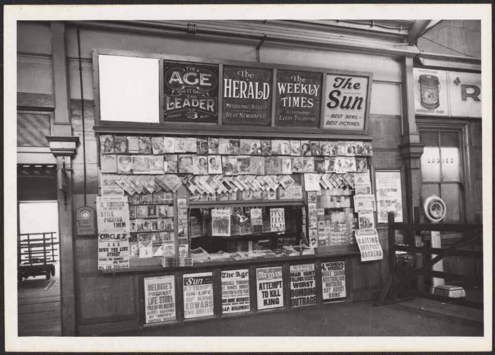 A newspaper stand with headlines about an attempt to kill the King