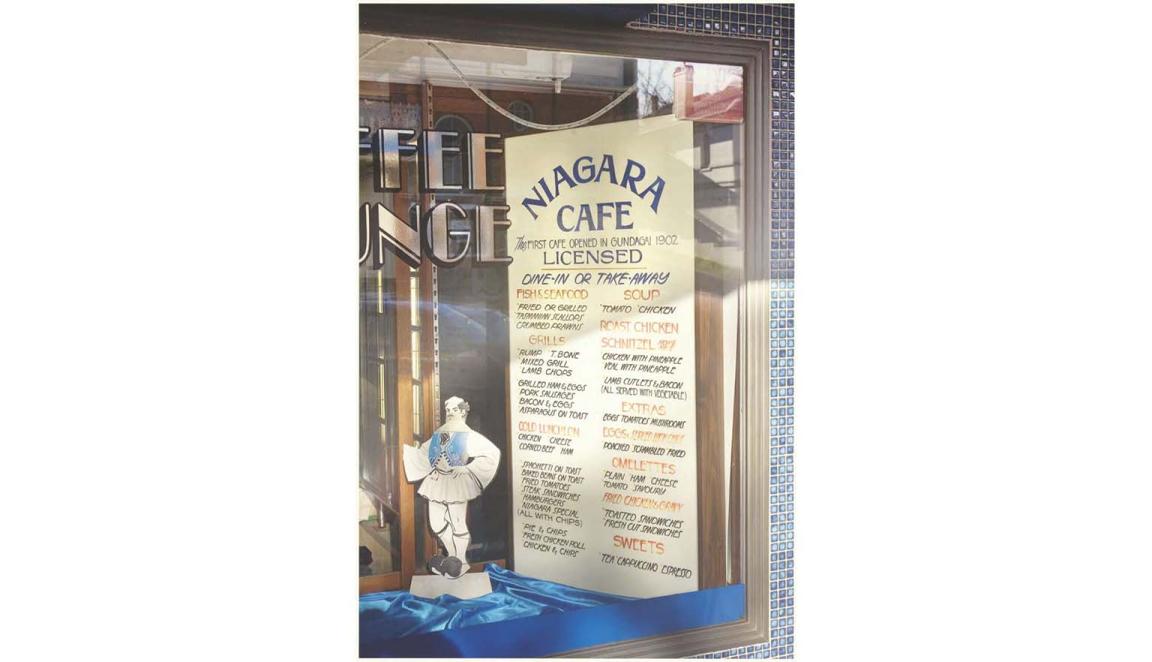 A photo of a menu in Greek displayed in a restaurant window in Gundagai, New South Wales.