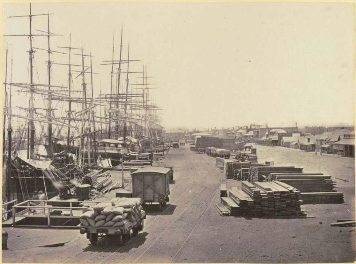 yellowed photograph of docks and trucks