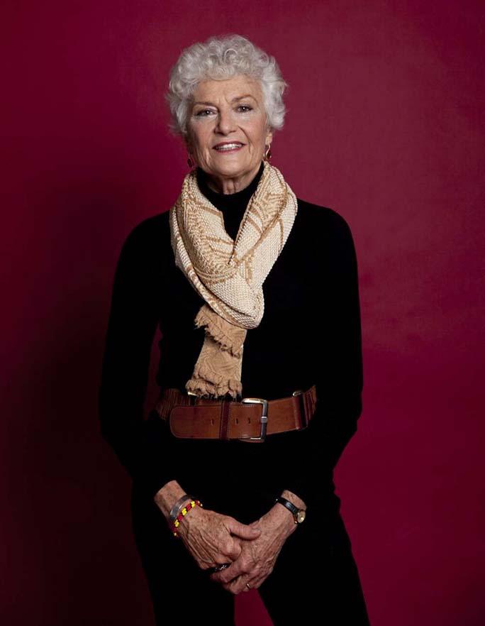 photo of a woman standing against a purple background