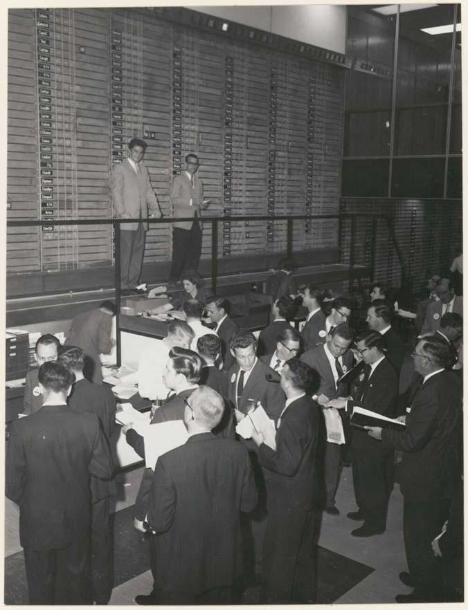 Black and white photo of men in the Sydney Stock Exchange, 1960