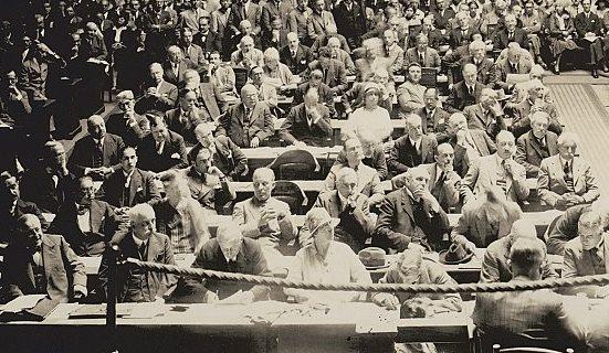 black and white photo of men sitting in a meeting