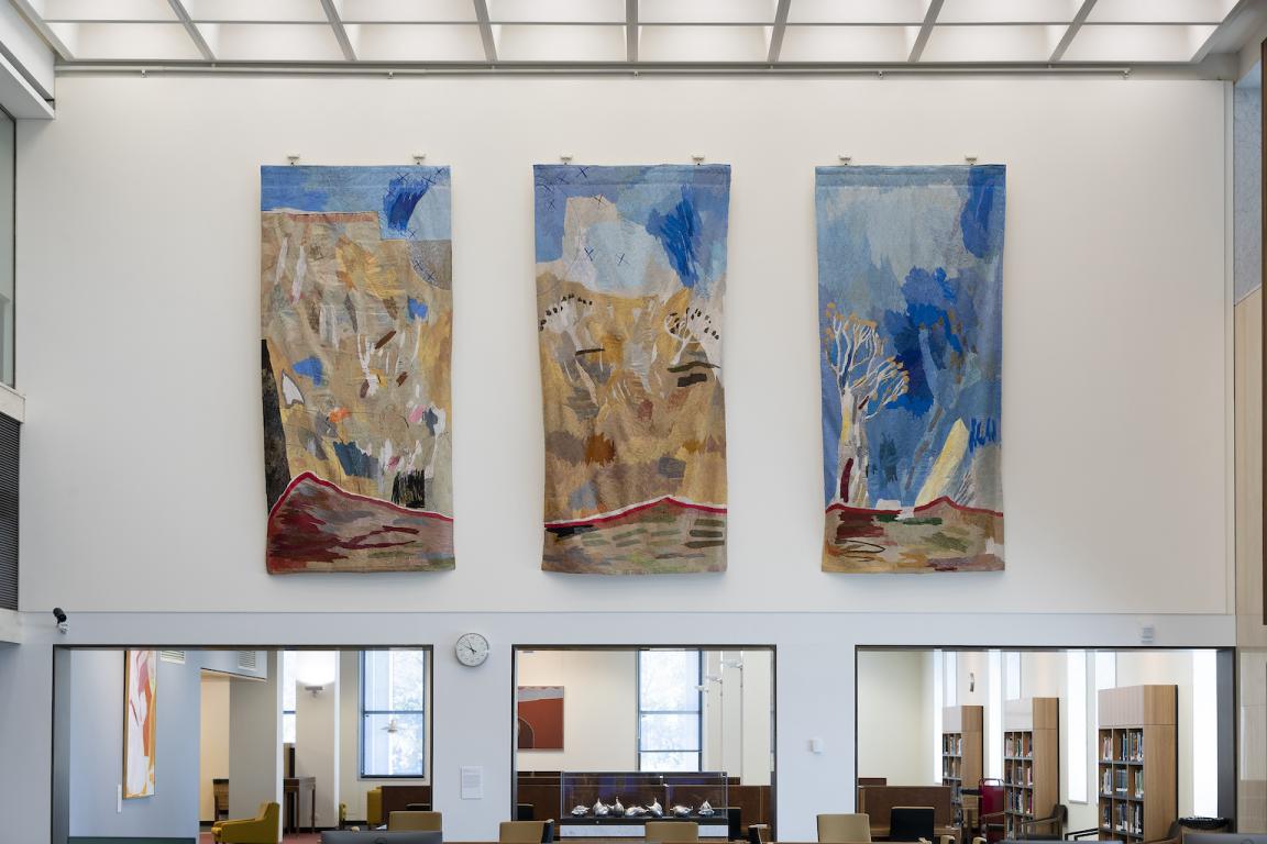 Three colourful tapestry panels depicting Australian landscapes hung in the main reading room