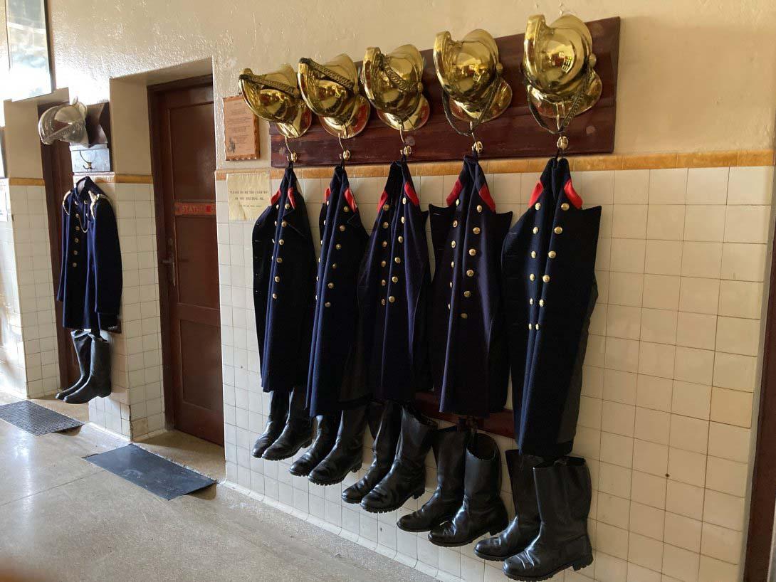 Turnout gear for firemen hanging in the engine bay of the Canberra Fire Museum