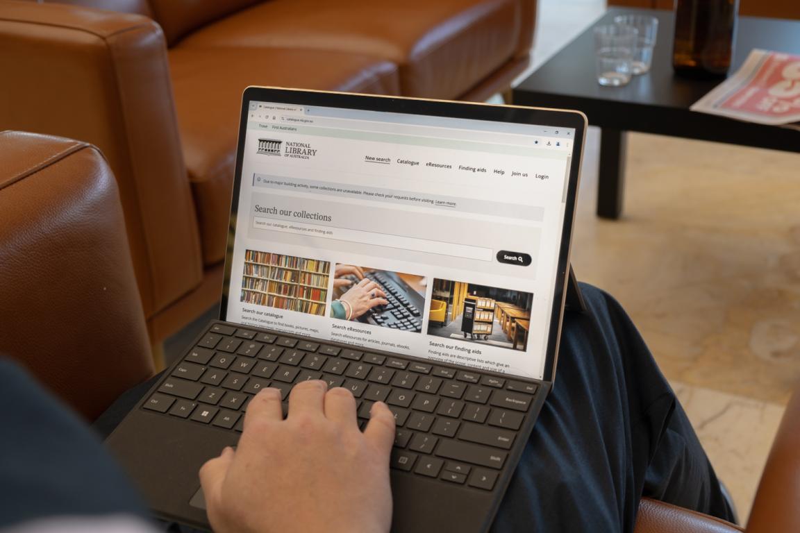 Man using a laptop to access the National Library catalogue
