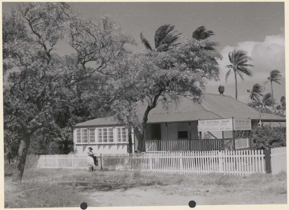 black and white photo of a building with a sign saying 'The National Bank'