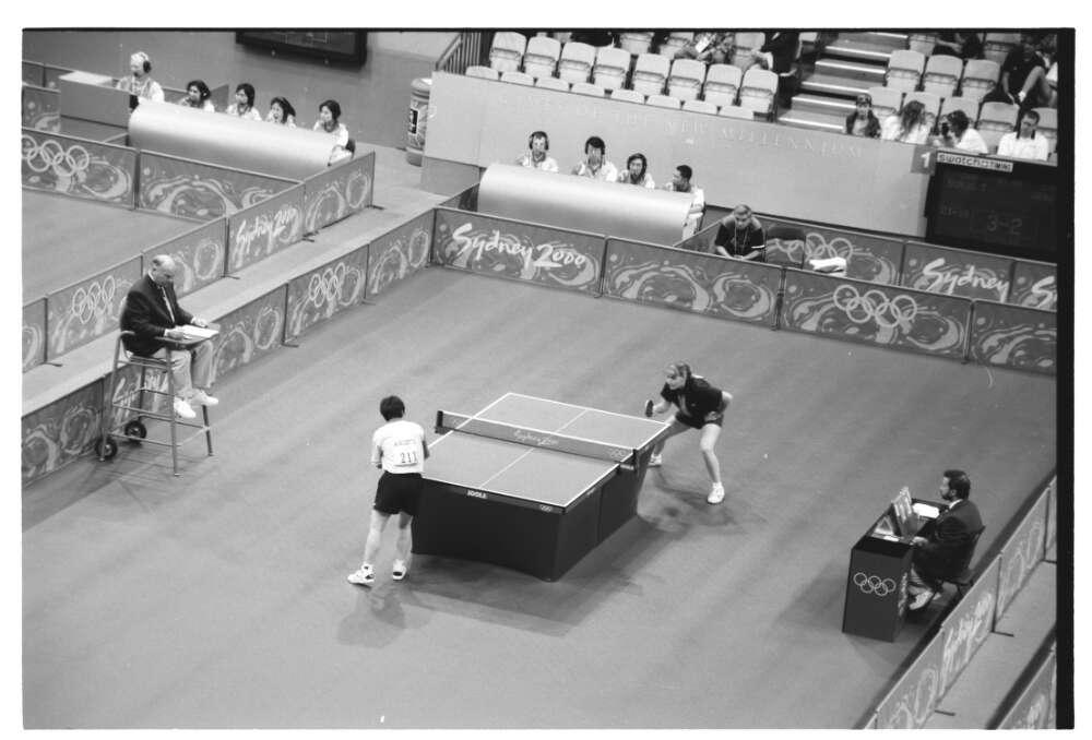 black and white photo of a women's table tennis match