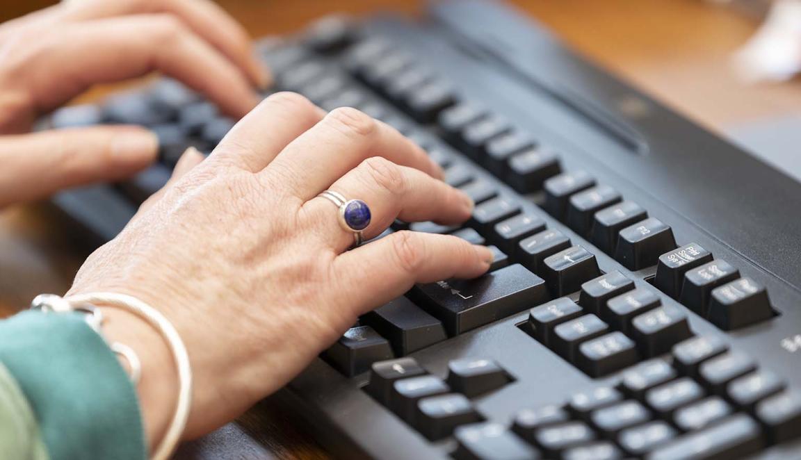 Hands typing on a keyboard