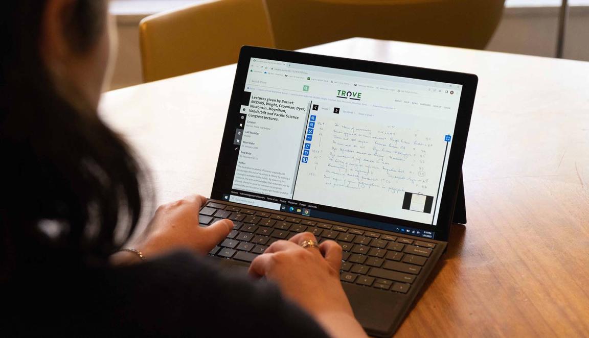 Person looking at the Trove website on a laptop