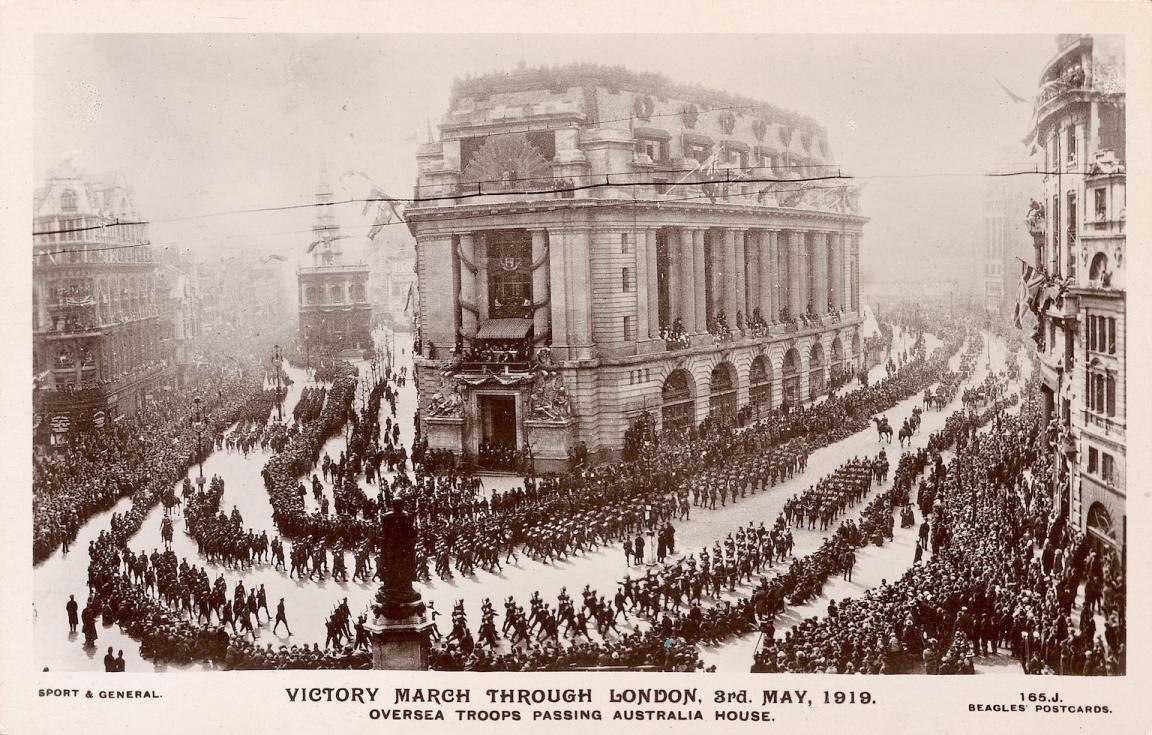 Troops marching on the street, lined by crowds, past the large Australia House building in London