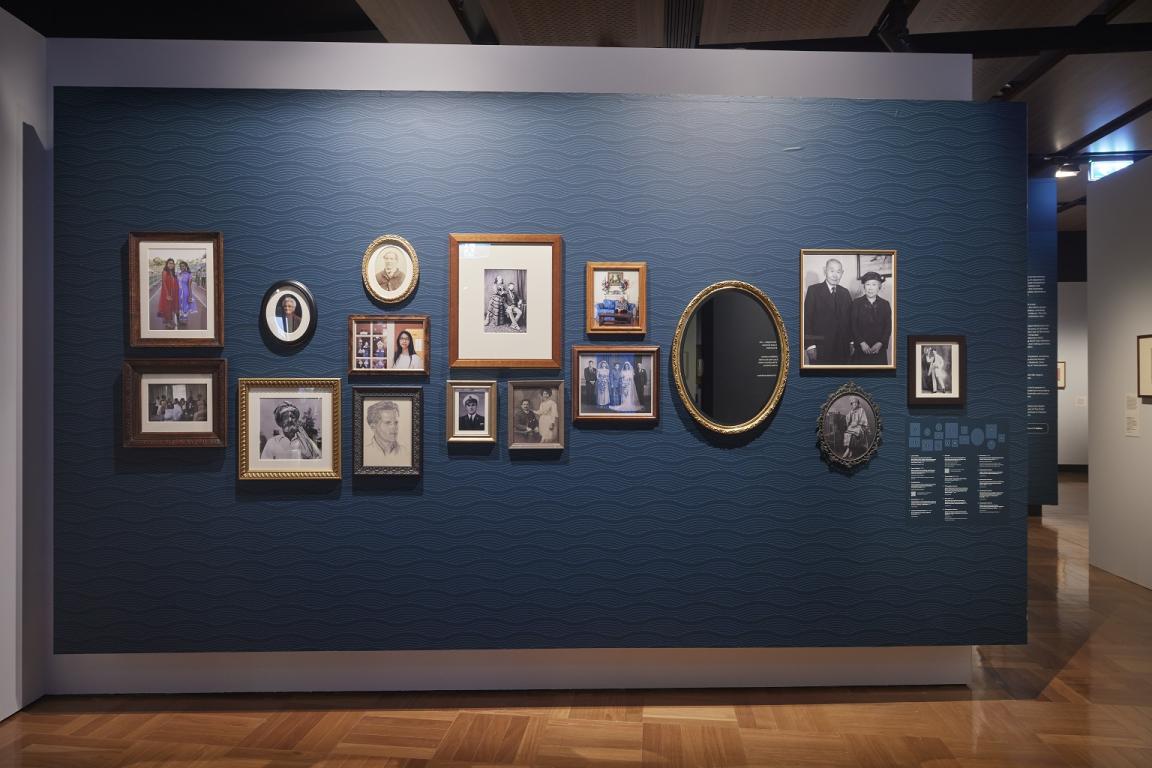 A wall at the entrance of the Library's Hopes and Fears exhibition decorated with framed family photos