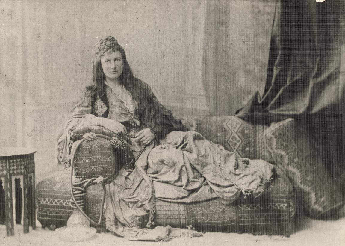 Woman, Jessie Catherine Couvreur, sitting sideways on a couch