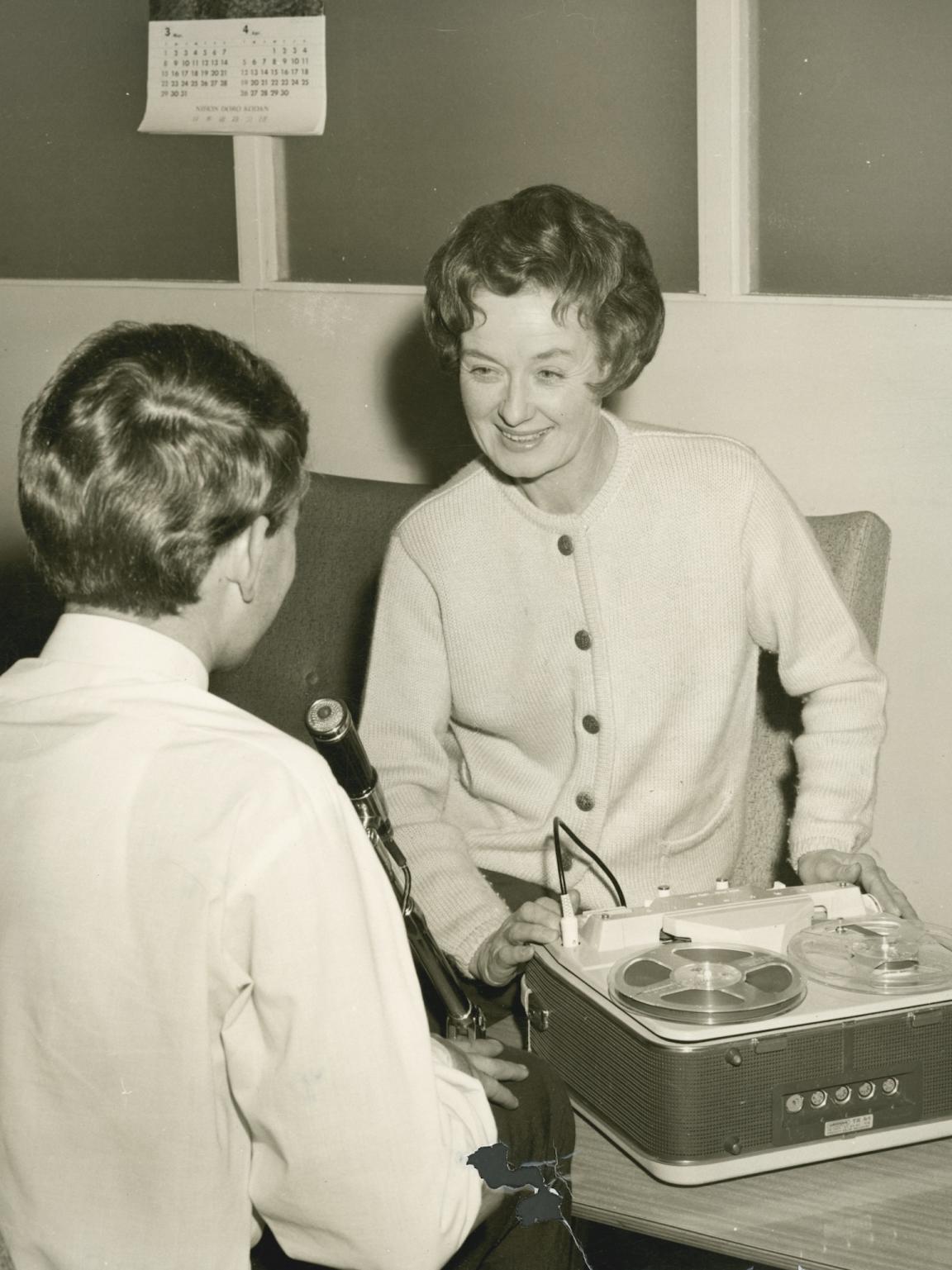 Sepia-toned photo of oral historian Hazel de Berg smiling while interviewing Michael Terry