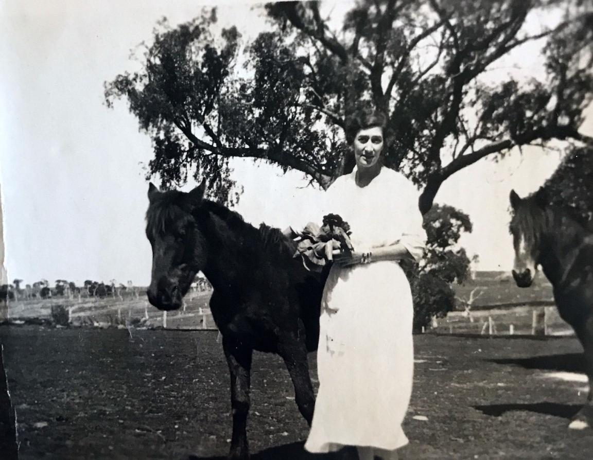 Black and white photograph of playwright Millicent Armstrong and two horses