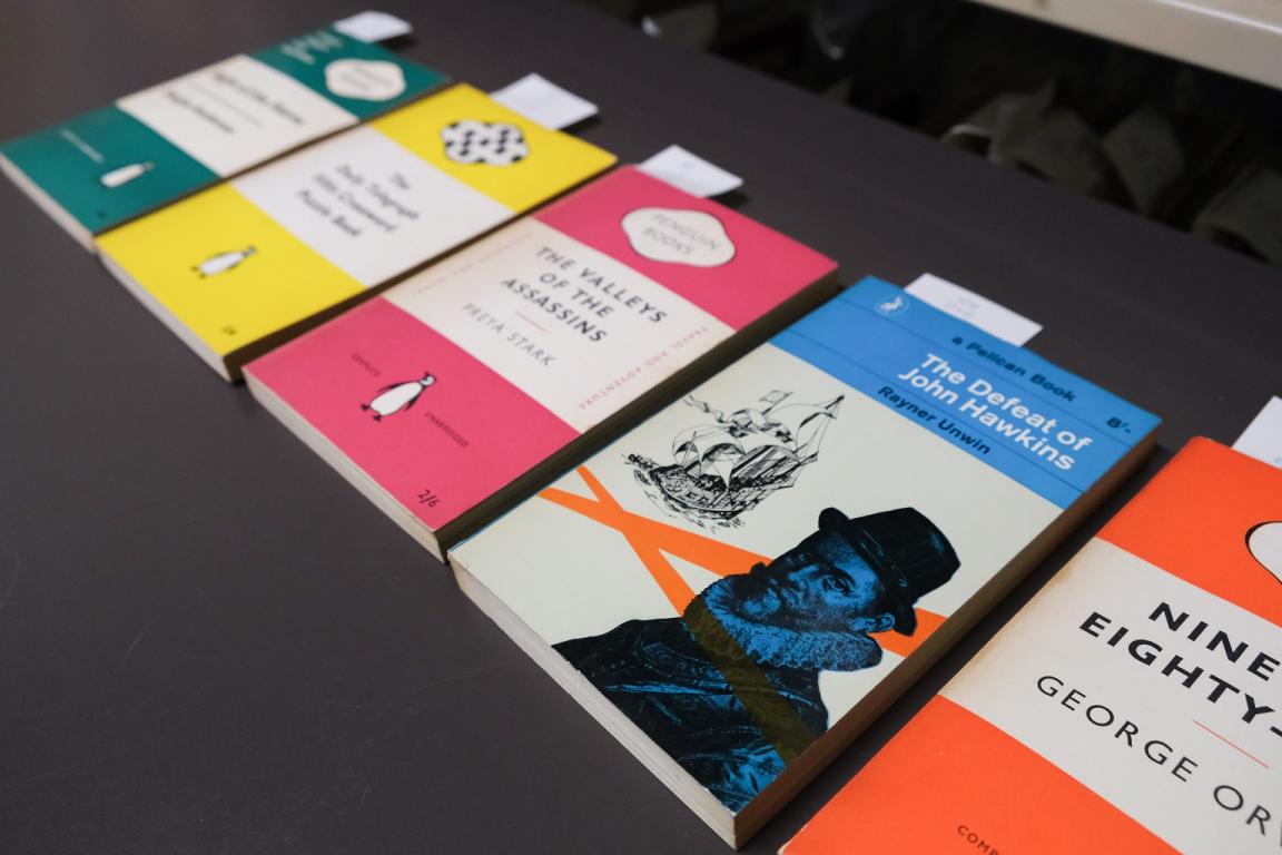 Five differently-colour books laid out in a row, all published by Penguin Random House and featuring their well known cover design