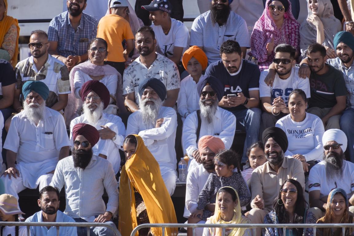 Spectators of all ages sitting in the stands watching the Australian Sikh Games